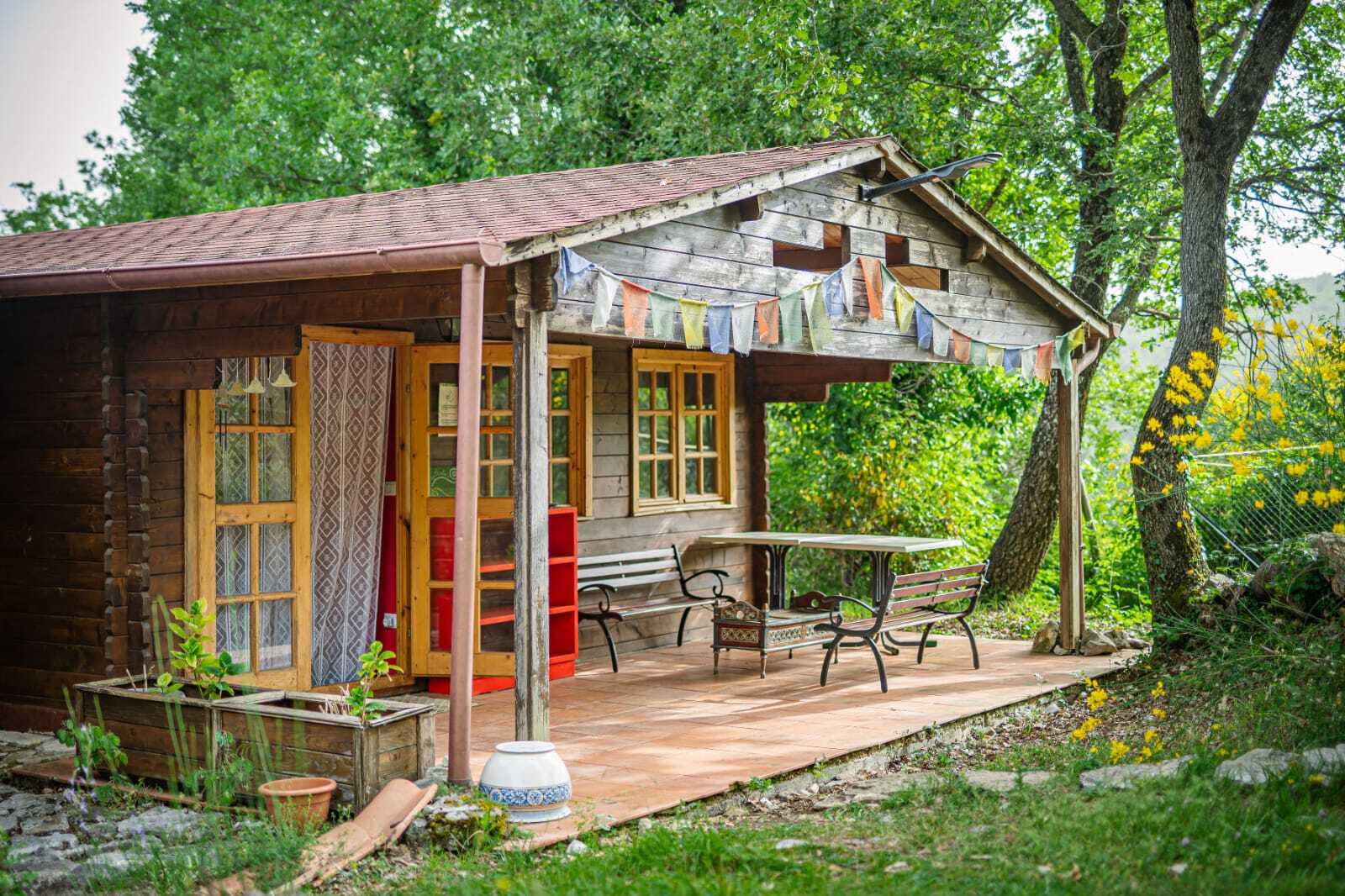 cottage in the woods at the left